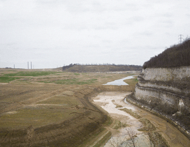 The chalk cliffs at the southern edge of the quarry. The pits at the bottom will be flooded to create lakes