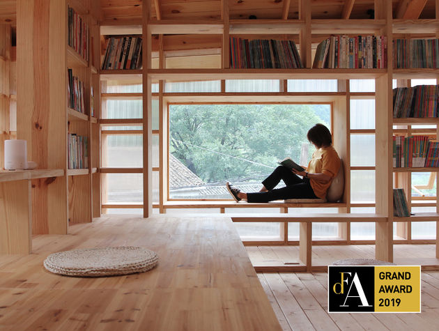 A woman reading a book in a modern reading room