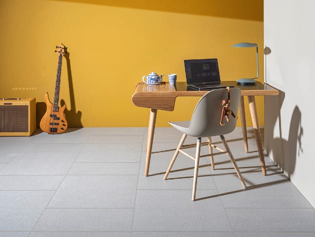tiled room with desk, chair, guitar and amp
