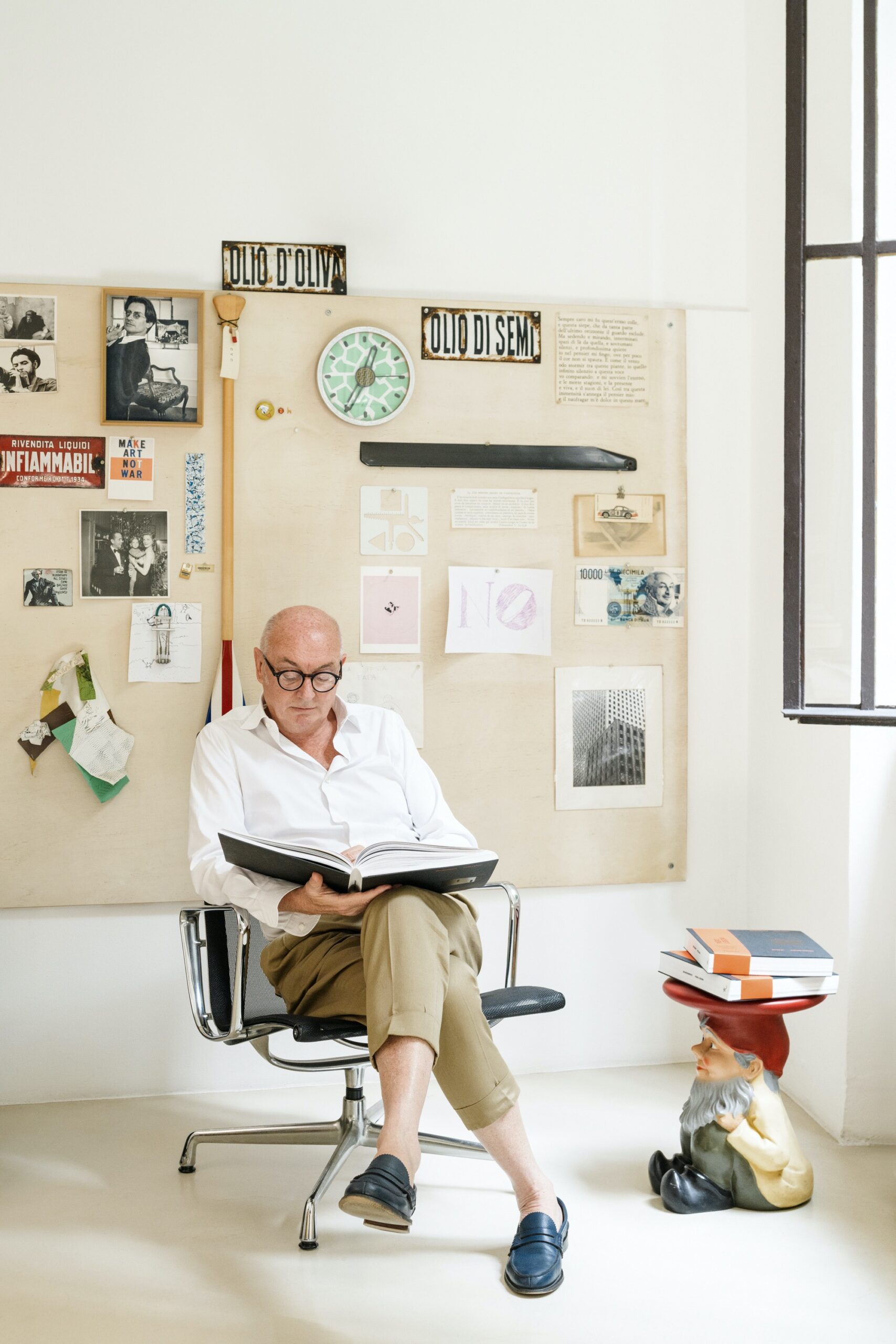 Piero Lissoni in his studio sitting on a chair
